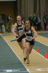 Janai Martens hands the baton to Maria Houle in the 4 x 400m relay at the 2017 Golden Bear Challenge. The Wolves team placed third in the race.